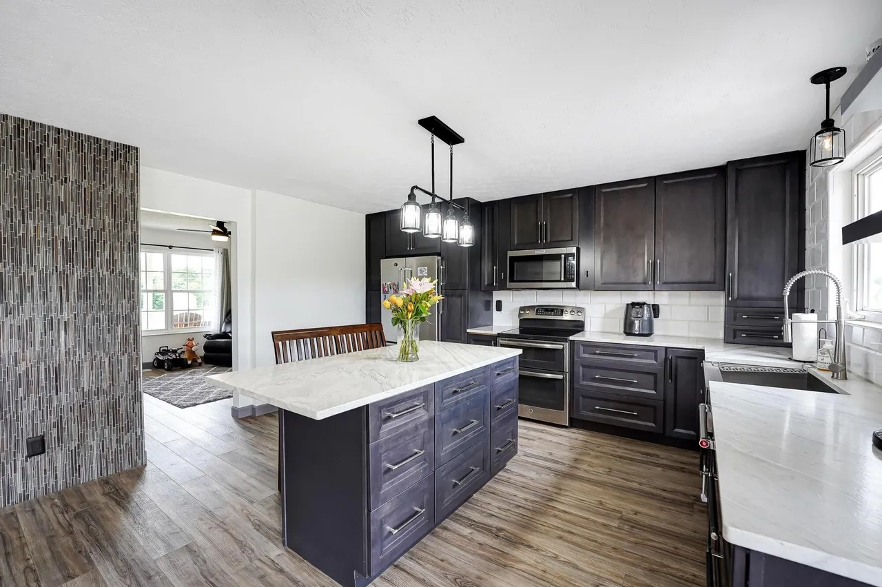 Open concept kitchen with mosaic tile accent wall